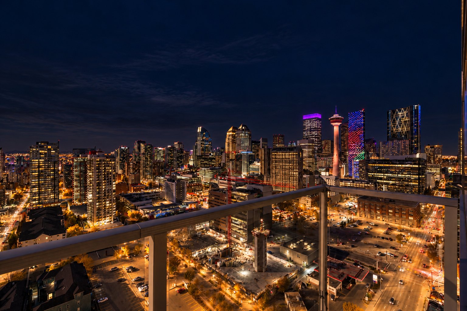 Downtown Calgary skyline and Calgary Tower lit up at night