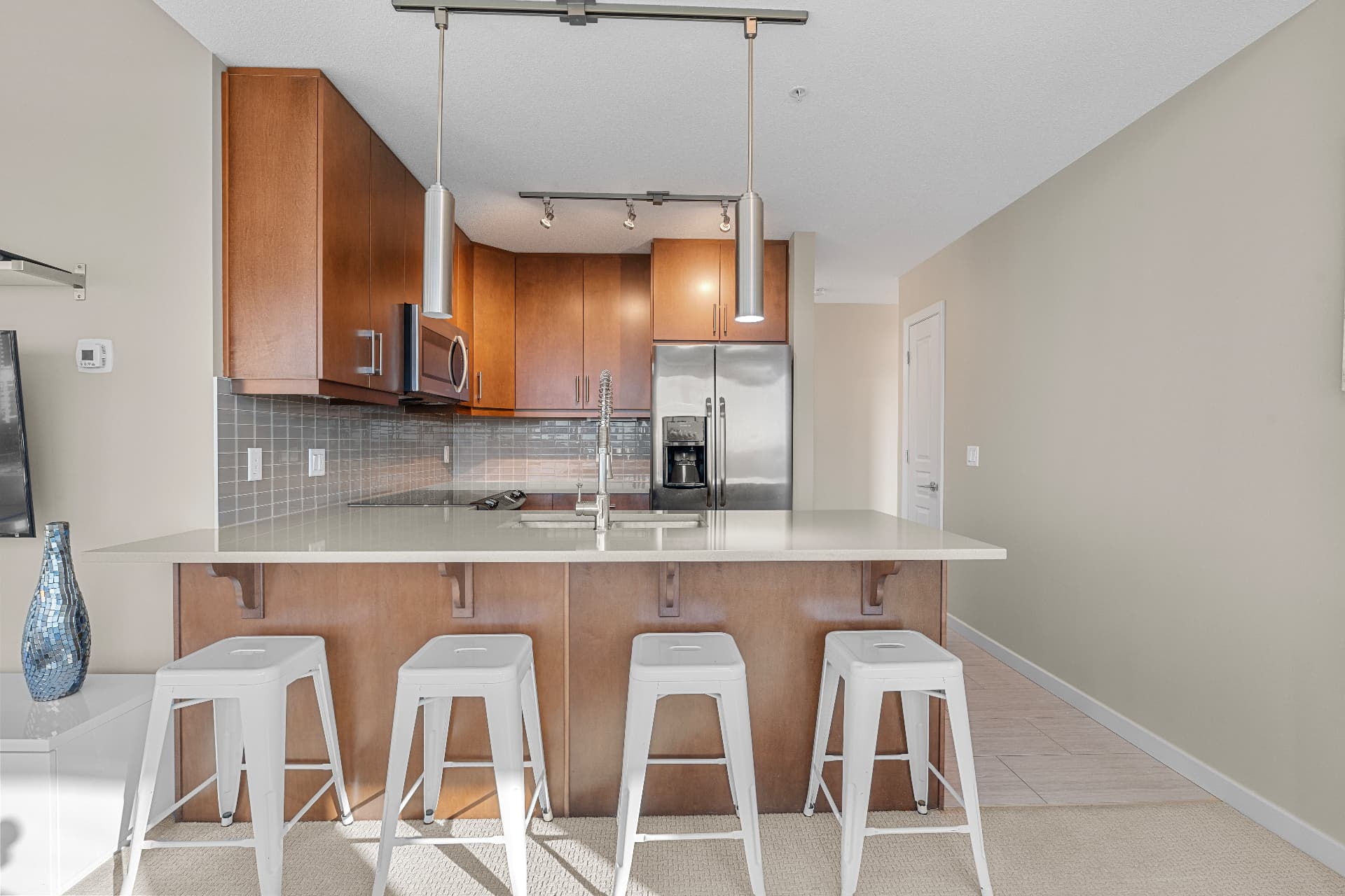 Kitchen with quartz island and stainless appliances