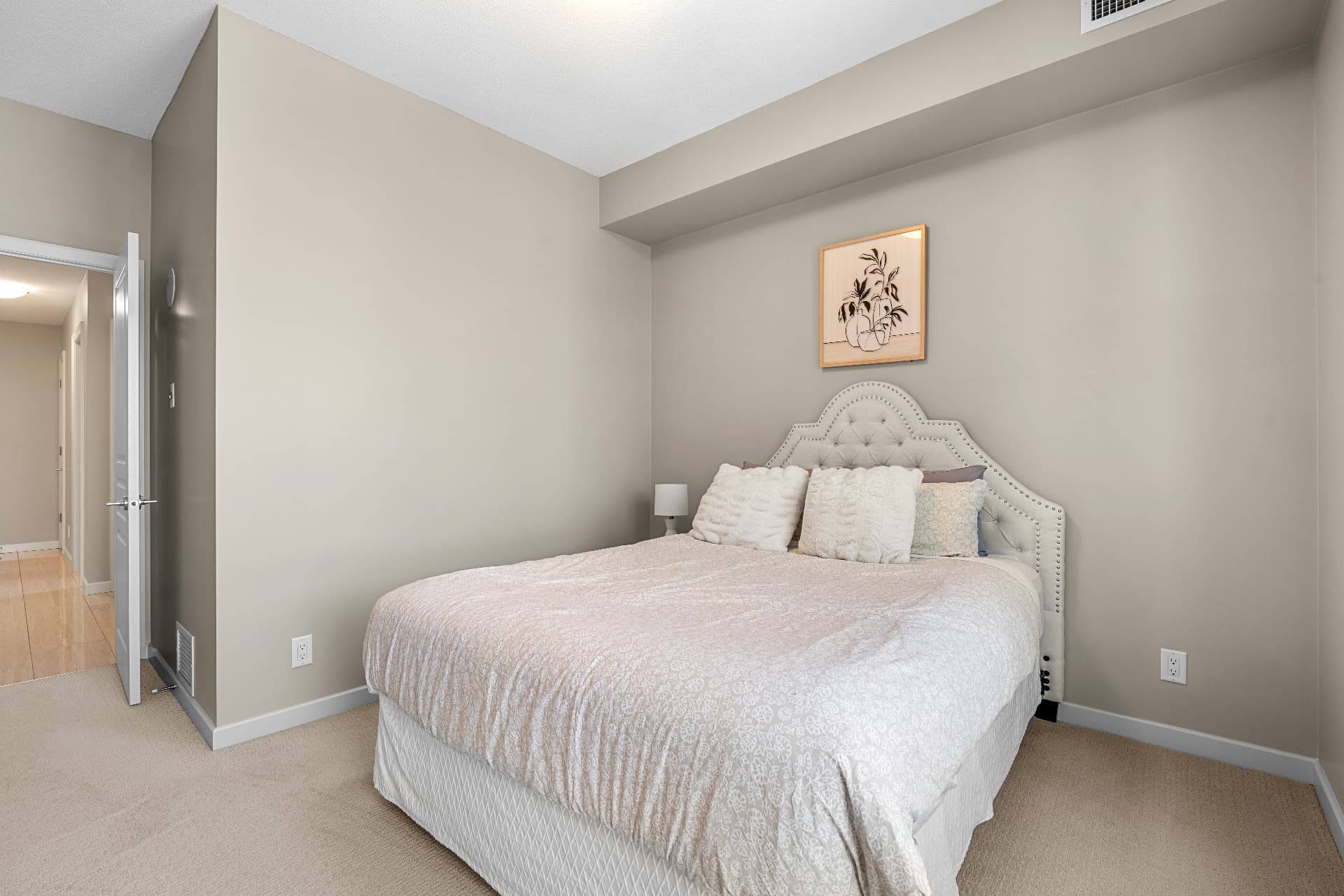 Primary bedroom with upholstered headboard